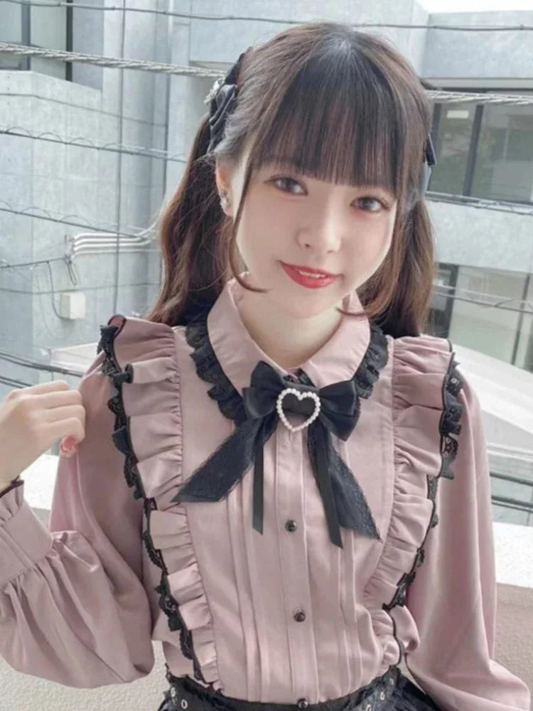 Pink bow-detailed lace ruffled blouse by eprolo featuring delicate lace and frills, perfect for a feminine, stylish look.