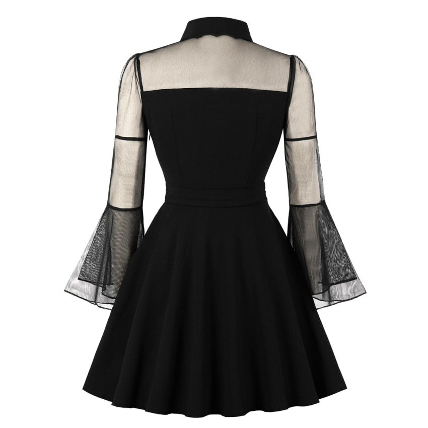 Eprolo black transparent mini dress with long sleeves and fitted silhouette, shown on a model.