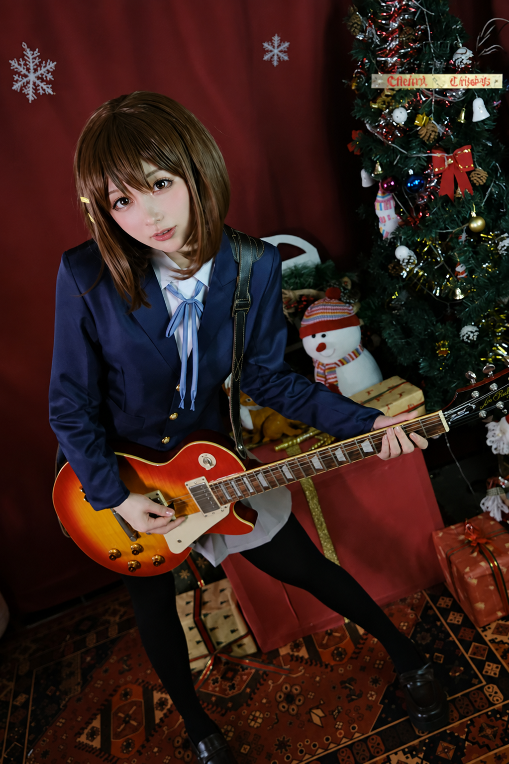 Yui Hirasawa cosplay costume and wig from K-On! featuring Shadora brand, with the character's signature brown hair and school uniform style.