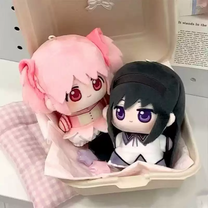 Shadora Madoka and Homura plush dolls, soft and detailed collectible figures from the anime series, on a plain background.