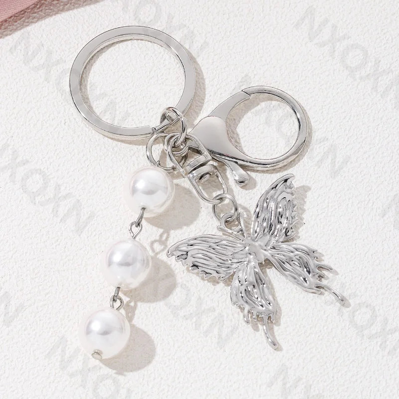 Eprolo keychain featuring a heart, butterfly, and star details, made of metal with intricate decorative design.
