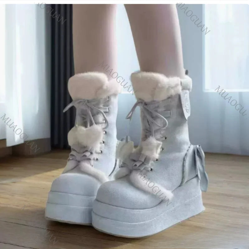 Eprolo fuzzy platform snow boots with bow detail, black peluş material, suitable for winter, featuring a durable sole and stylish design.