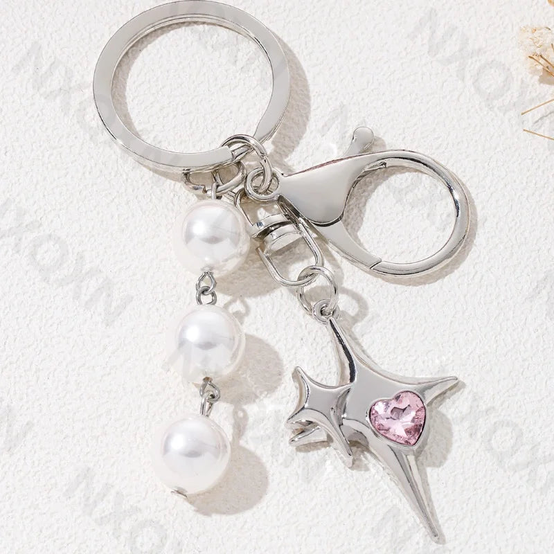 Eprolo keychain with butterfly, heart, and star details in metal, featuring intricate engraved designs and a keyring attachment.
