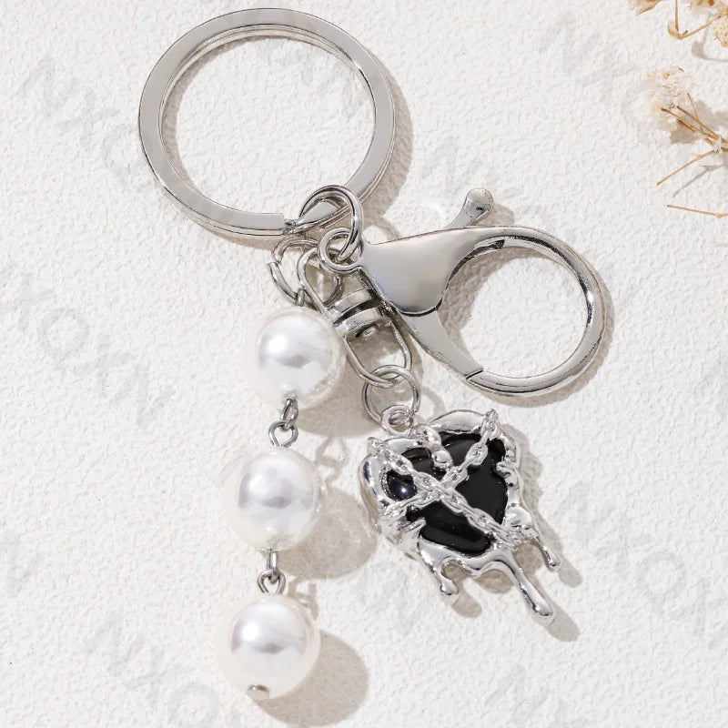 Eprolo keychain featuring heart, butterfly, and star details with colorful, intricate design on a solid background.
