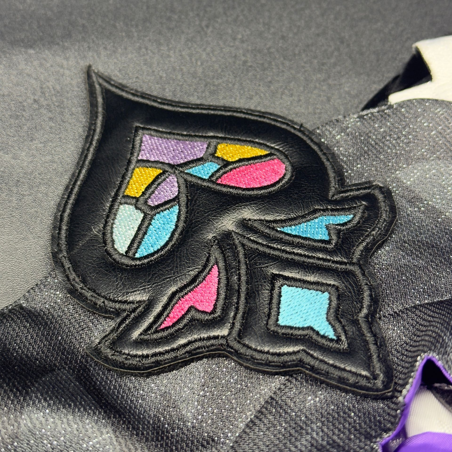 Black Swan cosplay costume from Honkai Star Rail, featuring detailed black and purple outfit with feather accents.