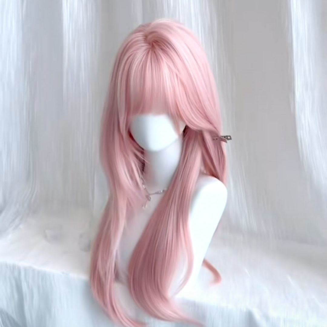 Shadora pink wig with long, wavy hair and bangs, styled for a vibrant, fashionable look.