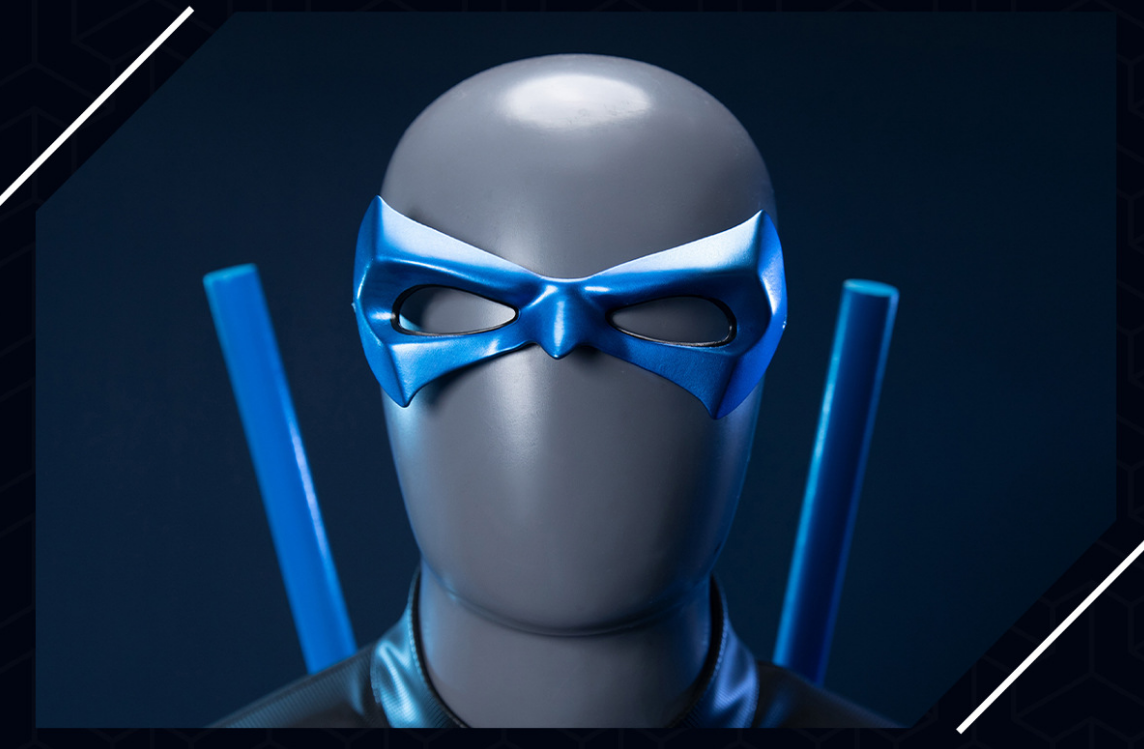 Nightwing Grayson cosplay costume by Shadora featuring a sleek black and blue suit with a mask and utility belt.