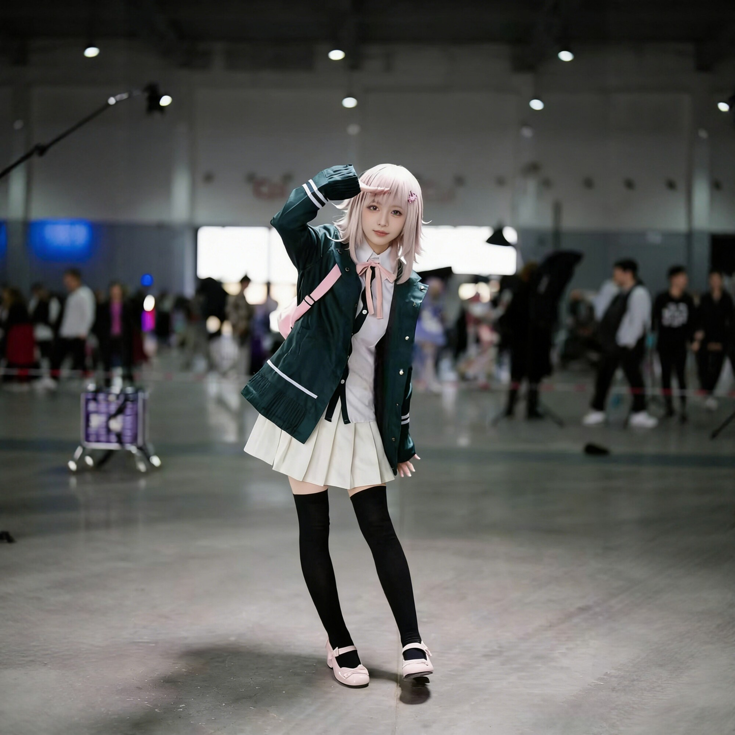 Chiaki Nanami cosplay with wig from Danganronpa, featuring character's signature outfit and short, light-colored hair.