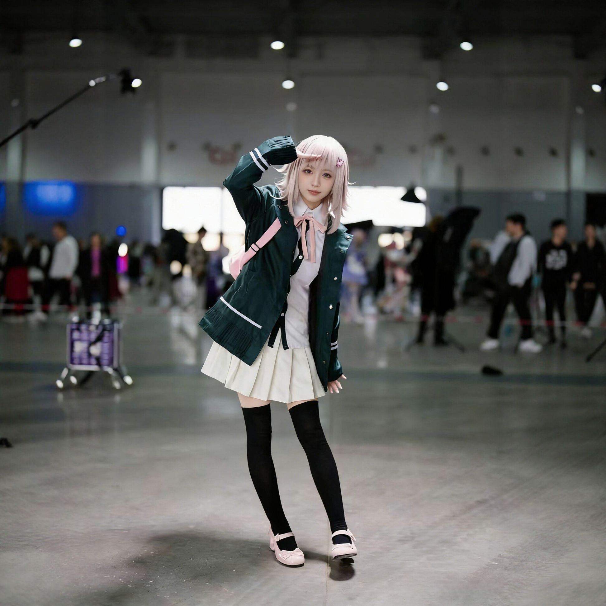 Chiaki Nanami cosplay with wig from Danganronpa, featuring character's signature outfit and short, light-colored hair.
