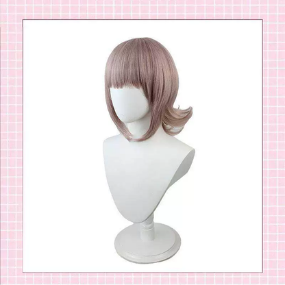Chiaki Nanami cosplay with wig from Danganronpa, featuring detailed costume and styled pink hair in natural lighting.